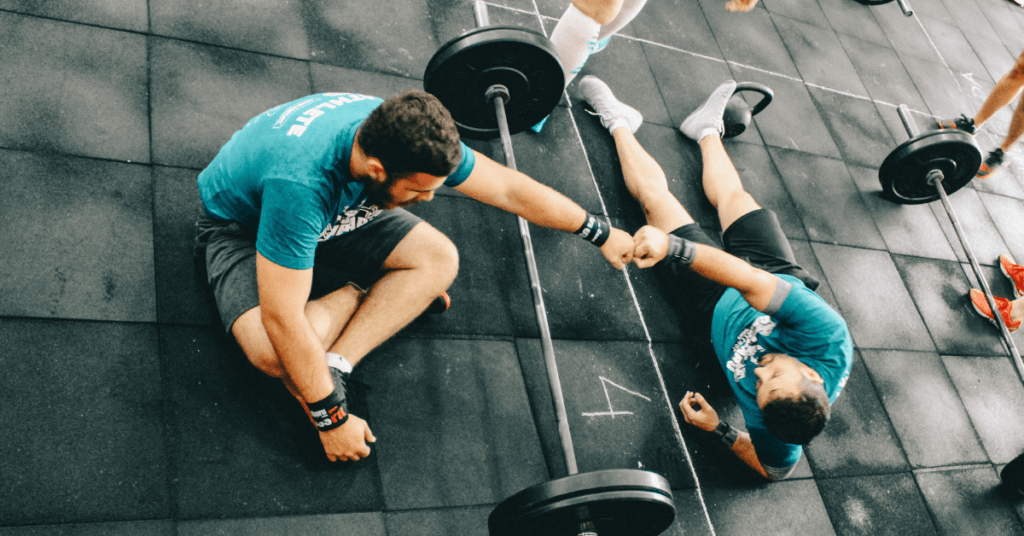 two men lying on the floor after a hard workout