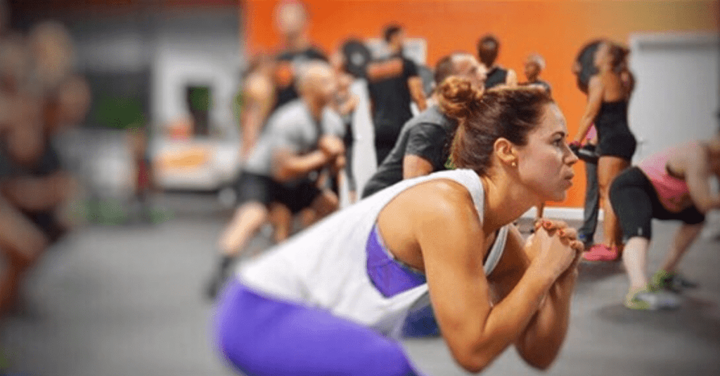 woman in an class performing squats