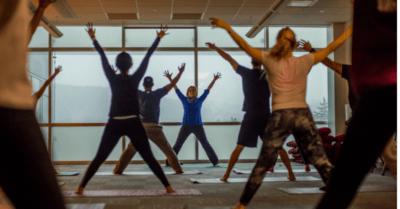 fitness class doing jumping jacks