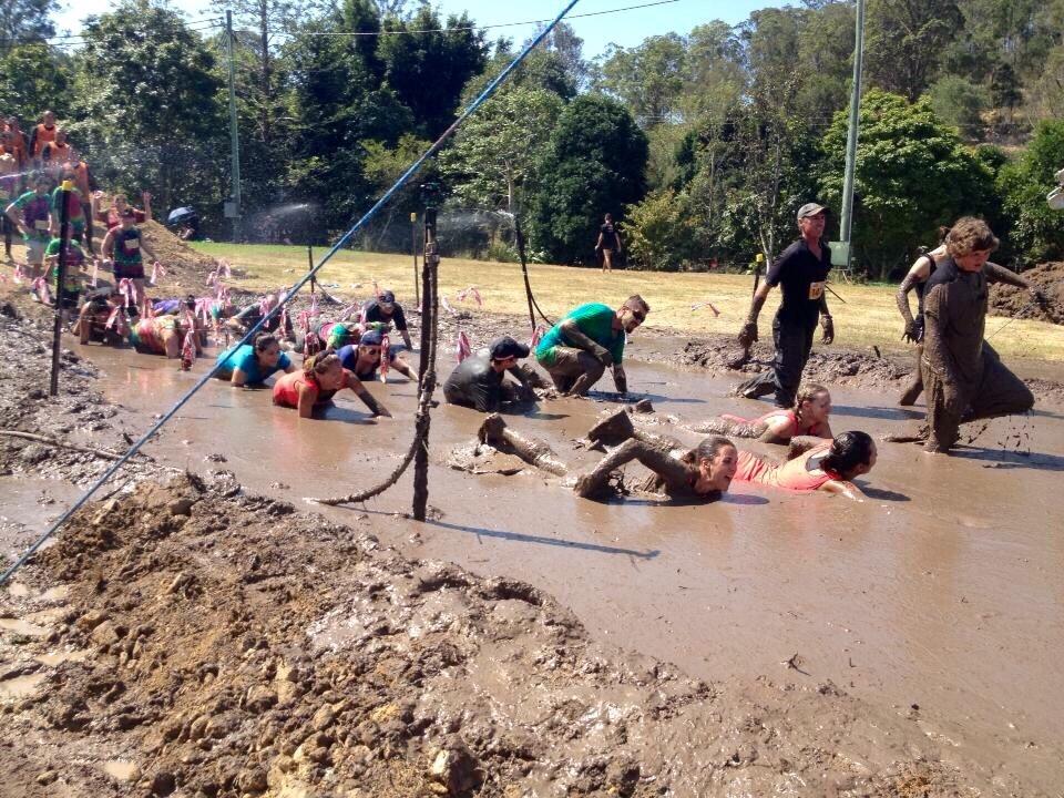 group of people in the mud