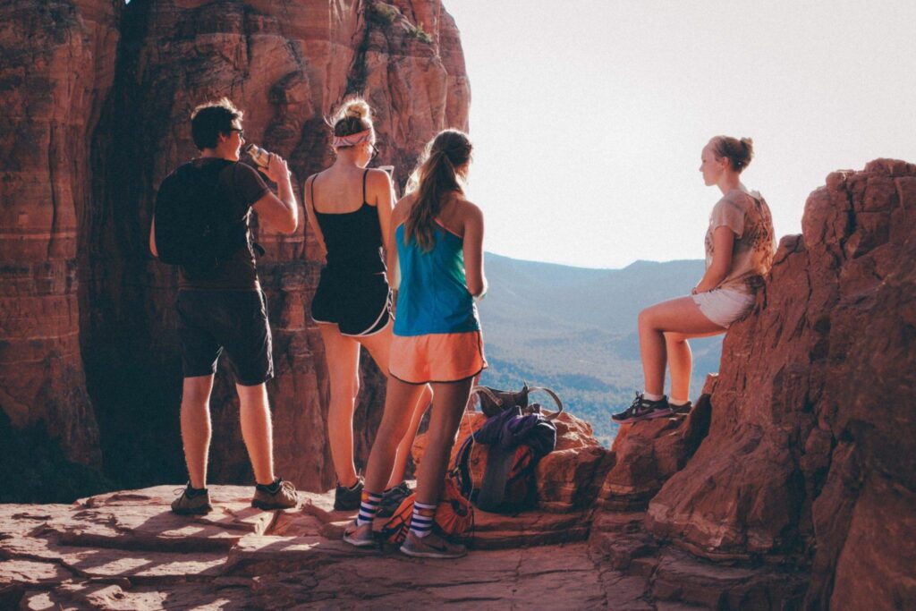 four people relaxing on a hike