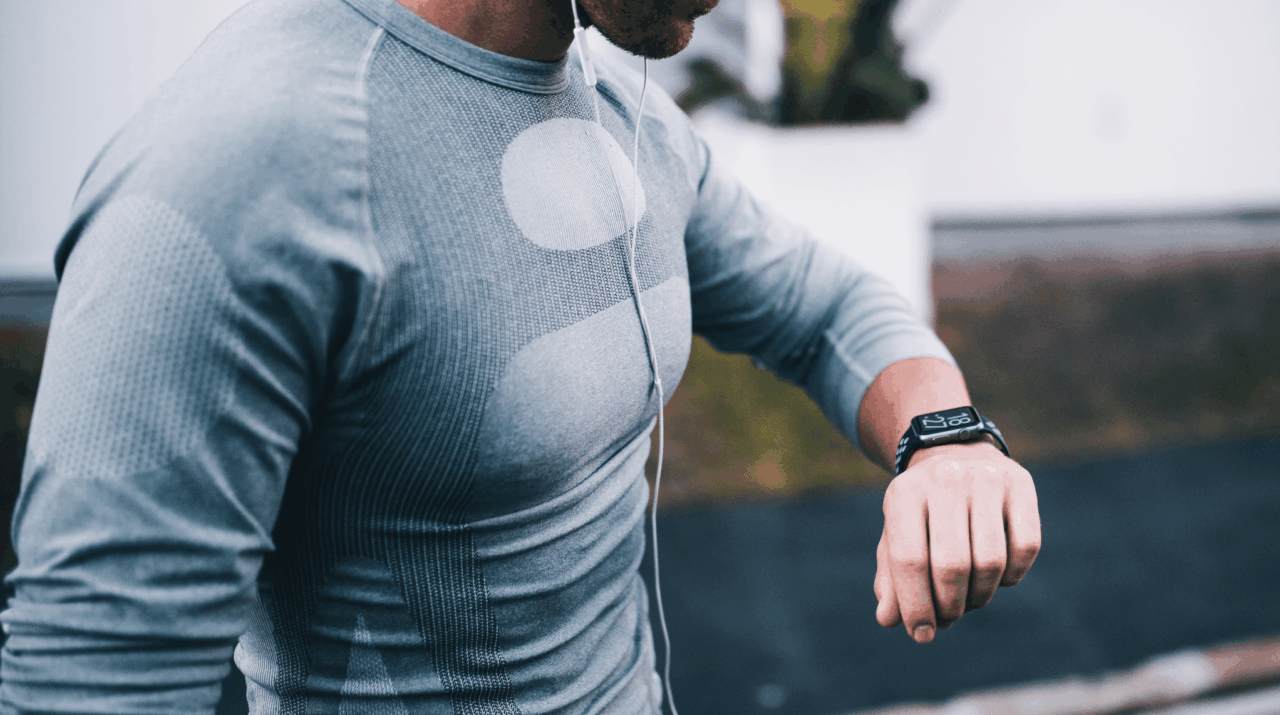 man looking a fitness tracker man looking a fitness tracker