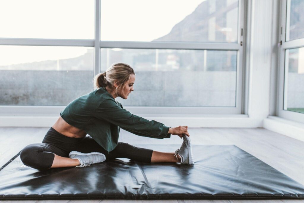 woman stretching on matt