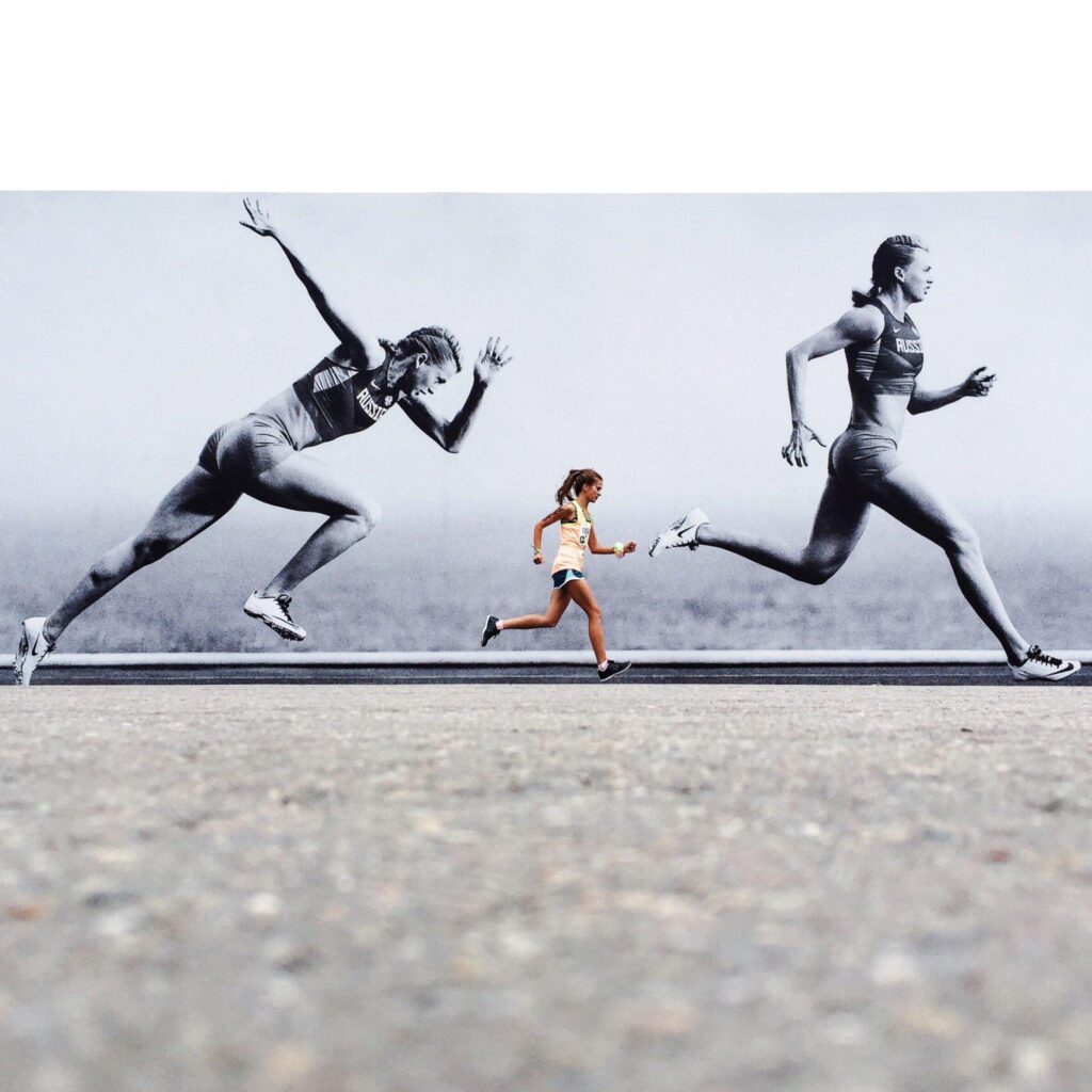 person running beside billboard