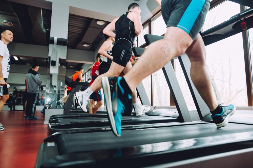 men running on a treadmill