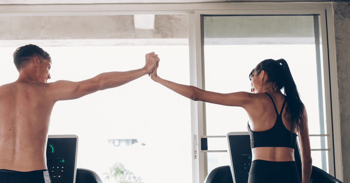 two people in the gym holding hands