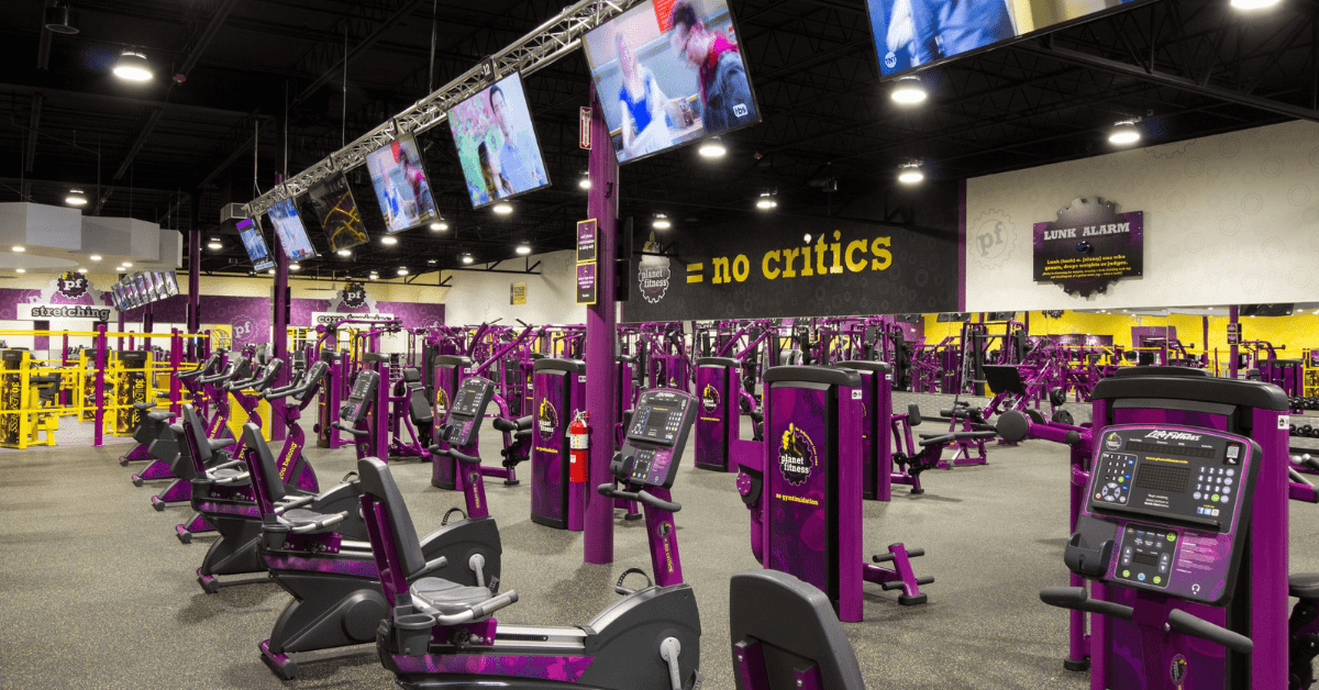an empty gym with purple gym equipment