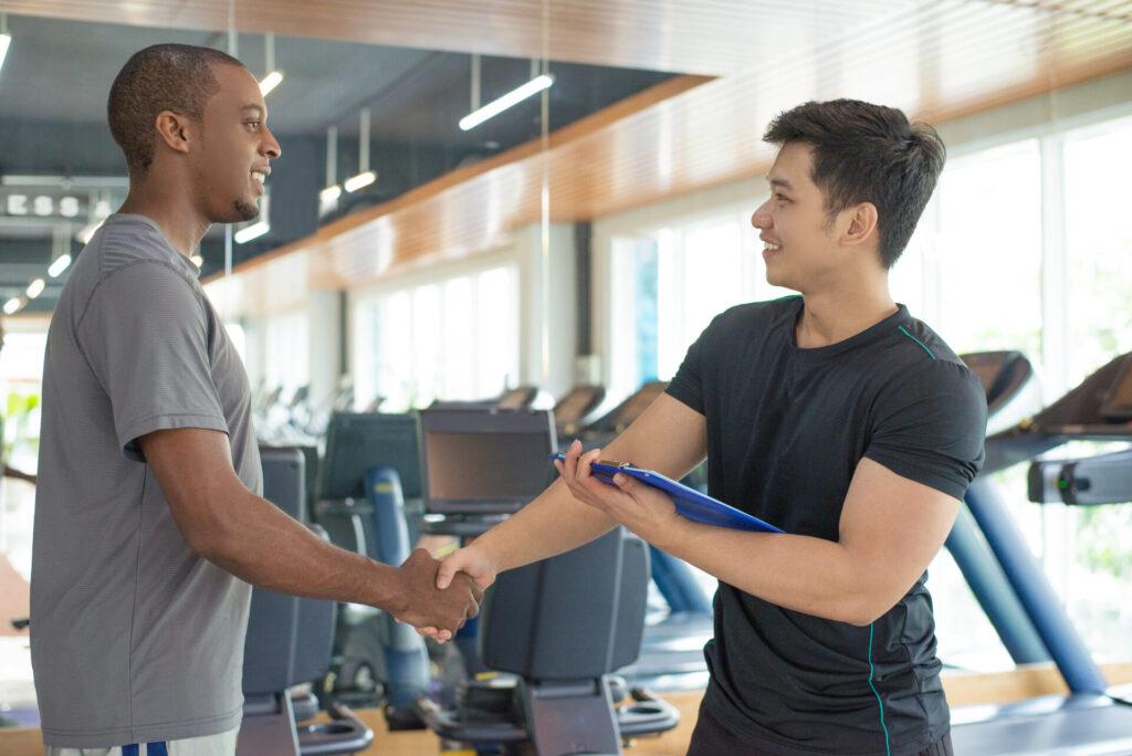 two men shaking hands over a gym deal..